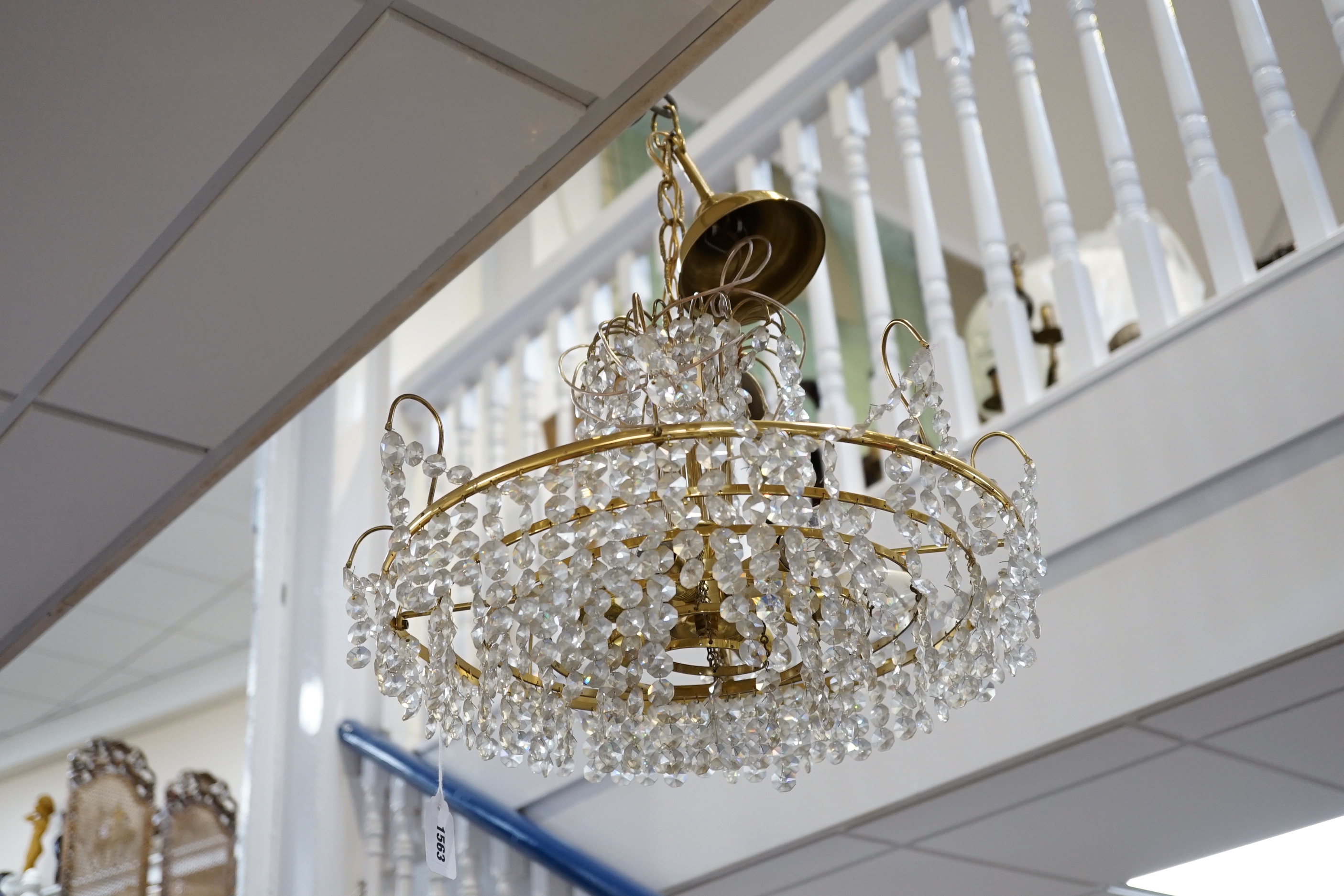 A three tier brass and glass chandelier, 44cm diameter